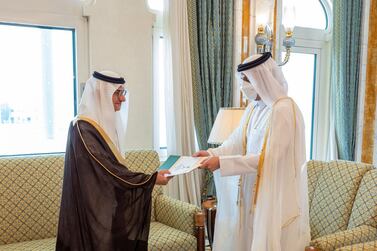 Qatar's Foreign Minister Sheikh Mohammed bin Abdulrahman Al Thani, right, receives a copy of the credentials of Saudi ambassador Prince Mansour bin Khalid. AFP