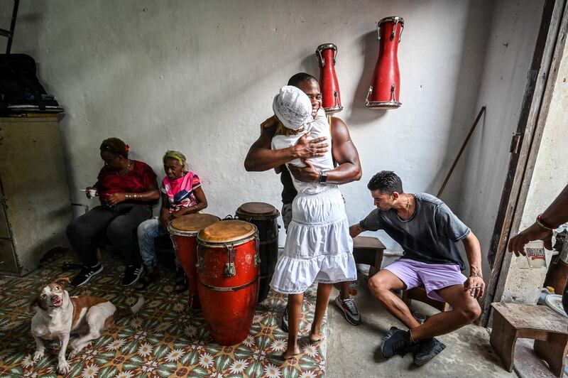 Cuban Iyanifa Aimee Ibanez, hugs a fellow follower of the Afro-Cuban Santeria religion at the celebration of her anniversary as Iyanifa – a woman who undertakes divination rituals – in Havana's Los Sitios neighbourhood. AFP