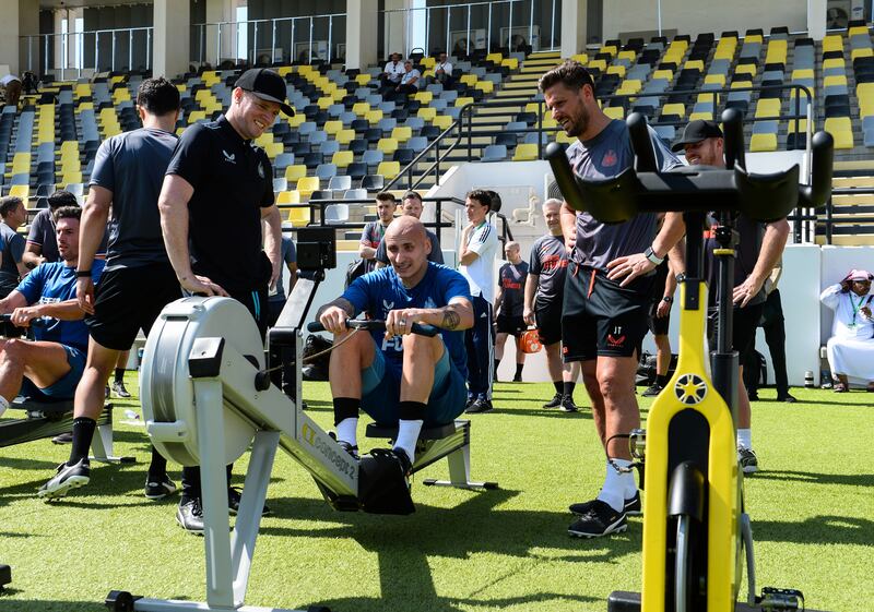 Newcastle midfielder Jonjo Shelvey on the rowing machine overseen by manager Eddie Howe, left, and his assistant Jason Tindall.