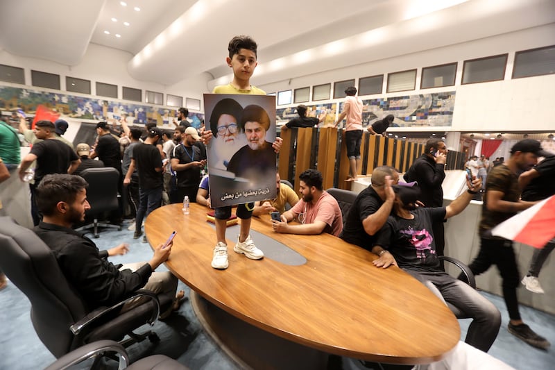 Supporters of Iraqi Shiite cleric Moqtada Al-Sadr, head of the Sadrist Movement, inside the Iraqi parliament building after they stormed the Green Zone in central Baghdad, July 27, 2022.  EPA