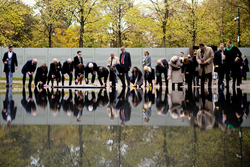 German President Frank-Walter Steinmeier, seventh from left, and others lay flowers at the memorial to the victims of the Sinti and Roma communities killed during the Holocaust on the 10th anniversary of the inauguration of the memorial in Berlin, Germany. AP
