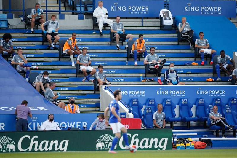 Leicester's replacements sit observing social distancing. AFP