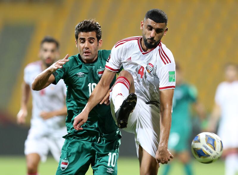 Shahin Abdulrahman of the UAE takes on Alaa Abdul Zahra of Iraq during their World Cup qualifier at the Zabeel Stadium in Dubai on October 12, 2021. Chris Whiteoak / The National