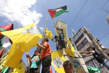 Palestinian protesters wave flags during a rally to celebrate the cease fire reached between Hamas and Israel, after an 11 day war, in the West Bank city of Jenin, May 22. EPA