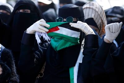 A woman holds a Palestinian flag during a march in solidarity with the Palestinian people in Sanaa, Yemen. EPA