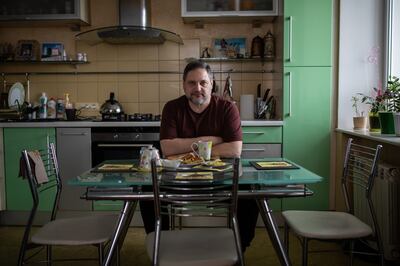 Andriy Dolmatov, chief foreman in the Port of Odesa, sits at his kitchen table in his apartment in Odesa. Oliver Marsden for The National