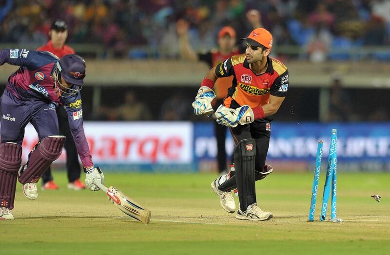 Sunrisers Hyderabad wicketkeeper Naman Ojha, right, successfully runs out Rising Pune Supergiants batsman Usman Khawaja. Noah Seelam / AFP
