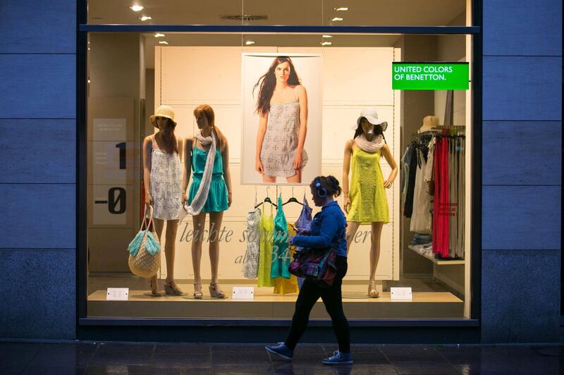 A pedestrian passes a United Colors of Benetton store window display, operated by Benetton Group SpA, in Bremen, Germany, on Tuesday, May 27, 2014. Germany's economic growth in the first quarter was driven exclusively by internal demand, highlighting the uneven nature of the euro area's recovery. Photographer: Krisztian Bocsi/Bloomberg