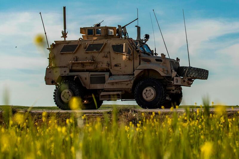 A US military vehicle, part of a convoy, advances near the town of Tal Tamr in the northeastern Syrian Hasakeh province, by the border with Turkey, on April 14, 2020. / AFP / Delil SOULEIMAN
