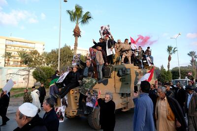 FILE PHOTO: Supporters of Libyan National Army (LNA) commanded by Khalifa Haftar, celebrate on top of a Turkish military armored vehicle, which LNA said they confiscated during Tripoli clashes, in Benghazi, Libya January 28, 2020. REUTERS/STAFF/File Photo