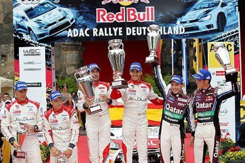 From left: Jarmo Lehtinen and Mikko Hirvonen, third placed from Finland; Carlos del Barrio and Dani Sordo, winners from Spain; and Nicolas Gilsoul and Thierry Neuville, second placed Belgians, celebrate during the victory ceremony at Rally Germany on Sunday. Thomas Frey / AP Photo