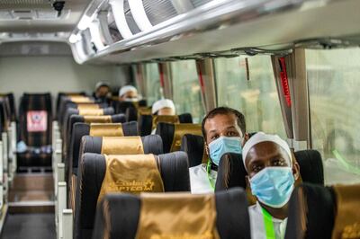 A handout picture provided by the Saudi Ministry of Hajj and Umra on July 25, 2020, shows travellers among the first group of arrivals for the annual Hajj pilgrimage, mask-clad and seated distantly from one another due to the COVID-19 coronavirus pandemic, riding on a bus transporting them from the Red Sea coastal city of Jeddah's King Abdulaziz International Airport. The 2020 hajj season, which has been scaled back dramatically to include only around 1,000 Muslim pilgrims as Saudi Arabia battles a coronavirus surge, is set to begin on July 29. Some 2.5 million people from all over the world usually participate in the ritual that takes place over several days, centred on the holy city of Mecca. This year's hajj will be held under strict hygiene protocols, with access limited to pilgrims under 65 years old and without any chronic illnesses. - === RESTRICTED TO EDITORIAL USE - MANDATORY CREDIT "AFP PHOTO / HO / MINISTRY OF HAJJ AND UMRA" - NO MARKETING NO ADVERTISING CAMPAIGNS - DISTRIBUTED AS A SERVICE TO CLIENTS ===
 / AFP / Saudi Ministry of Hajj and Umra / - / === RESTRICTED TO EDITORIAL USE - MANDATORY CREDIT "AFP PHOTO / HO / MINISTRY OF HAJJ AND UMRA" - NO MARKETING NO ADVERTISING CAMPAIGNS - DISTRIBUTED AS A SERVICE TO CLIENTS ===
