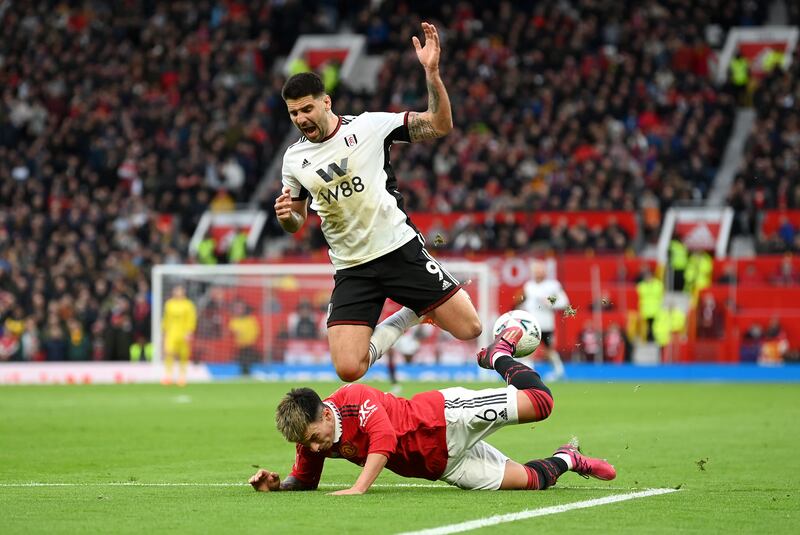 Fulham striker Aleksandar Mitrovic of Fulham is challenged by Lisandro Martinez of United. Getty