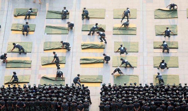 University students participate a competition of folding quilts during a military training at the start of a new semester in Hengyang, Hunan Province, China. Reuters