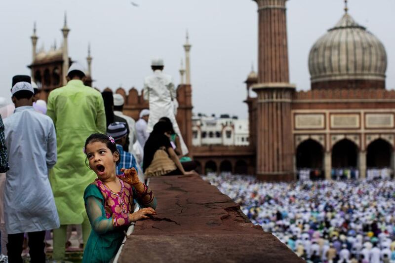 A young Indian Muslim yawns during Eid al-Fitr prayers at the Jama Masjid mosque in New Delhi, India. Bernat Armangue / AP Photo