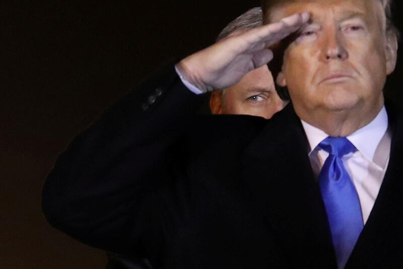 US President Donald Trump salutes the transfer cases holding the remains of US Army soldiers during a dignified transfer at Dover Air Force Base, in Dover, Delaware, USA. Reuters