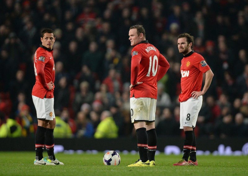 From left to right, Manchester United players Javier Hernandez, Wayne Rooney and Juan Mata react during their loss to Manchester City at Old Trafford on Tuesday. Peter Powell / EPA / March 25, 2014
