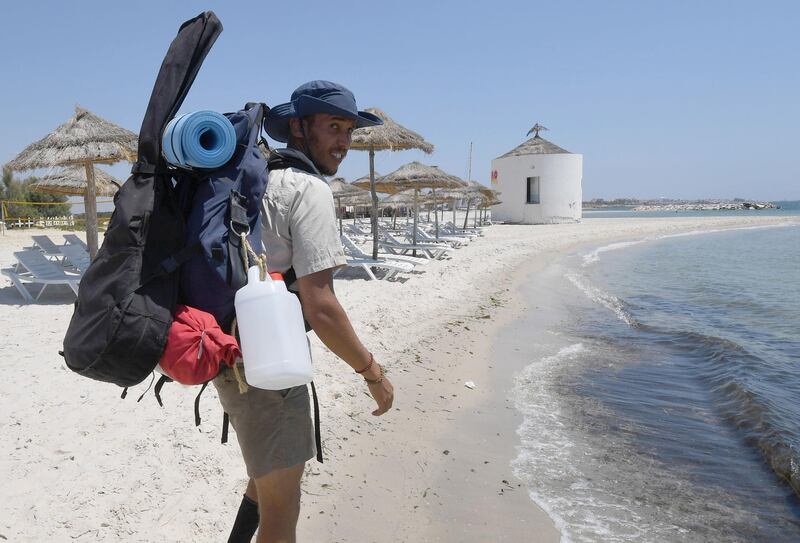 Mohamed Oussama walks along the Nabuel beach in northern Tunisia. The 27-year-old engineer set out in July to walk a 300 kilometre stretch of Tunisian coastline cleaning up a string of 30 beaches along the way. AFP