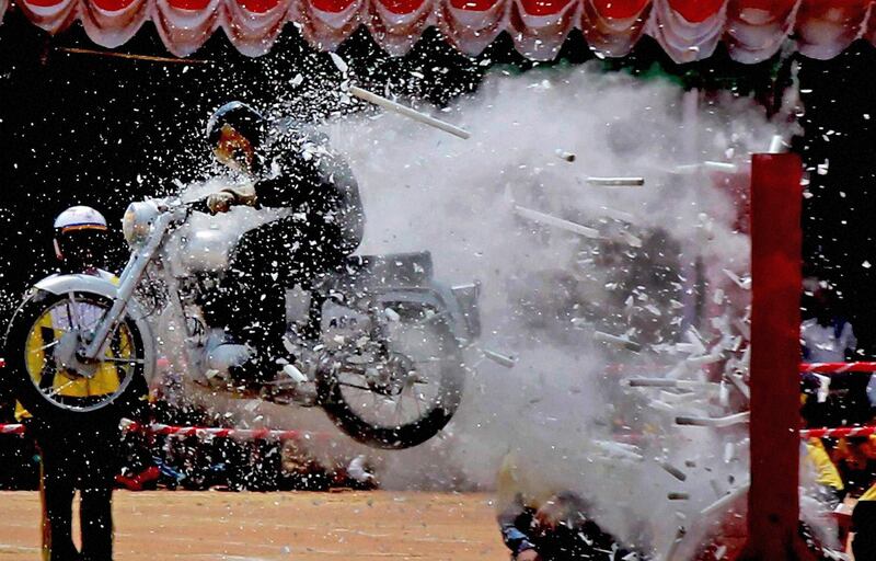 An Indian army stuntman performs on his motorcycle during Independence Day celebrations in Bangalore, India, Monday, Aug. 15, 2011. India marked 64 years of independence from British rule. (AP Photo) INDIA OUT *** Local Caption ***  India Independence Day.JPEG-08f99.jpg