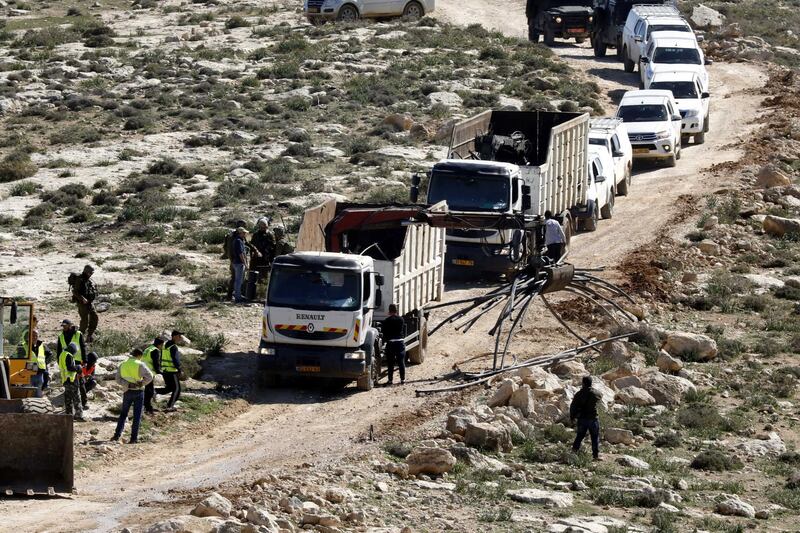 epa07366912 Israeli workers demolish water network on a Palestinian land near the West Bank city of Yatta, south of Hebron, 13 February 2019. Israeli authorities regularly demolish constructions and makeshift infrastructure of Palestinian residents who do not have needed permits to build or establish infrastructure in area C which is under the Israeli control in the occupied West Bank.  EPA/ABED AL HASHLAMOUN