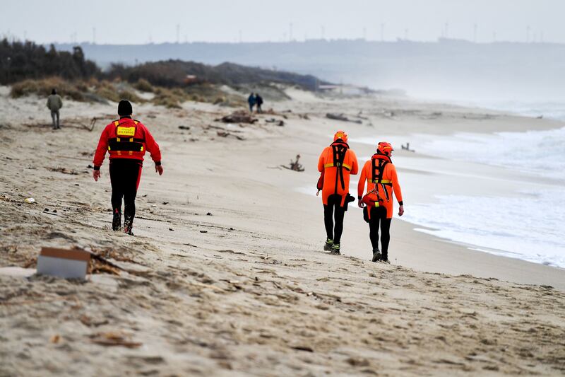 Divers of the Firefighters Corps patrol the beach. AFP
