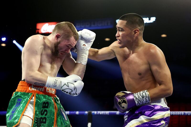 Gabriel Flores Jr. (R) punches Matt Conway during their junior lightweight bout at MGM Grand Garden Arena in Las Vegas.  AFP