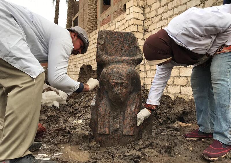 Archaeologists cleaning a newly-discovered fragment of a statue of ancient Egyptian Pharaoh Ramesses II, found at a private plot of land in the village of Mit Rahinah, near the historical site of Memphis and the Saqqara necropolis, south of the Egyptian capital Cairo. AFP