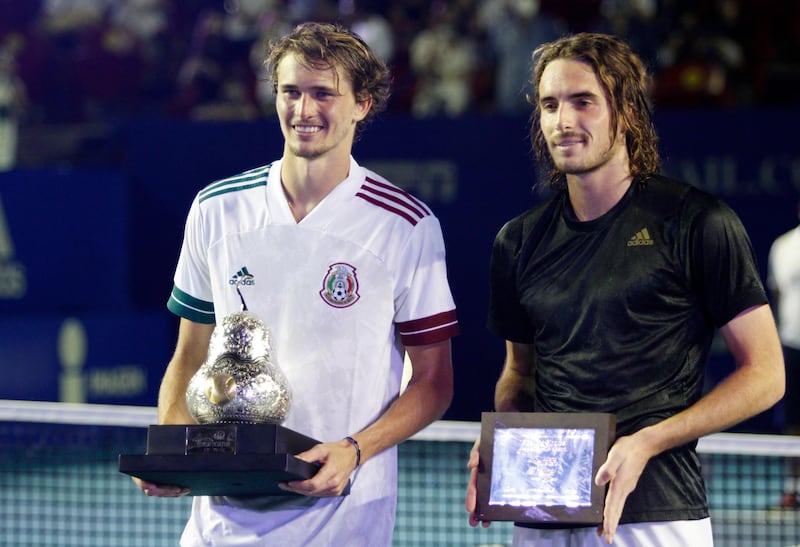 Alexander Zverev, left, celebrates with the winner's trophy after winning the Mexican Open with second-placed Stefanos Tsitsipas. Reuters