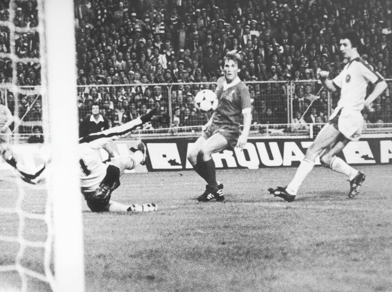 Kenny Dalglish of Liverpool watches apprehensively after chipping the ball past FC Bruges goalkeeper Birger Jensen in the European Cup final at Wembley, 11th May 1978. The shot was successful and won the match for Liverpool 1-0. 
(Photo by Central Press/Hulton Archive/Getty Images)