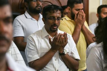 Sri Lankans offer prayers for the hundreds killed in a series of bomb blasts in the country on Easter Sunday.  Khushnum Bhandari for The National