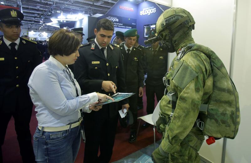 Visitors look at displayed exhibits during the EDEX Egypt Defence Exhibition 2018, in Cairo.  EPA