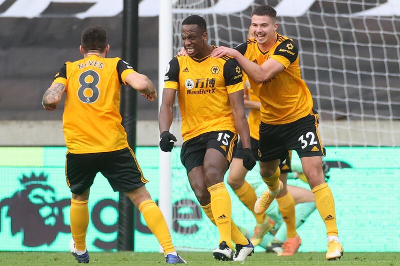 Wolves' Willy Boly, centre, celebrates with teammates after scoring his team's second goal. AFP