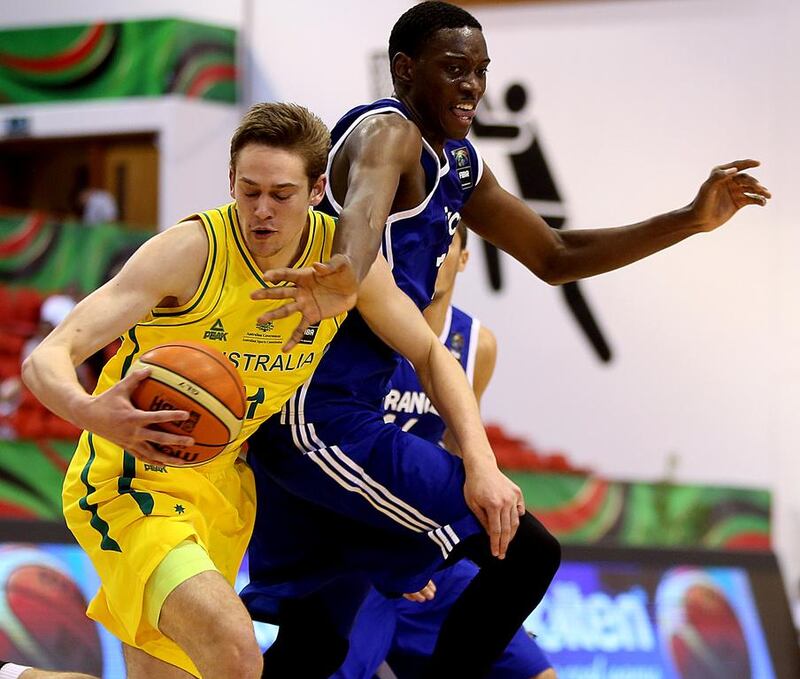 Kyle Clark, left, of Australia and Stephane Gombauld of France jostle for the ball during their Fiba Under 17 World Championship at Al Ahli club in Dubai on August 9, 2014. Satish Kumar / The National