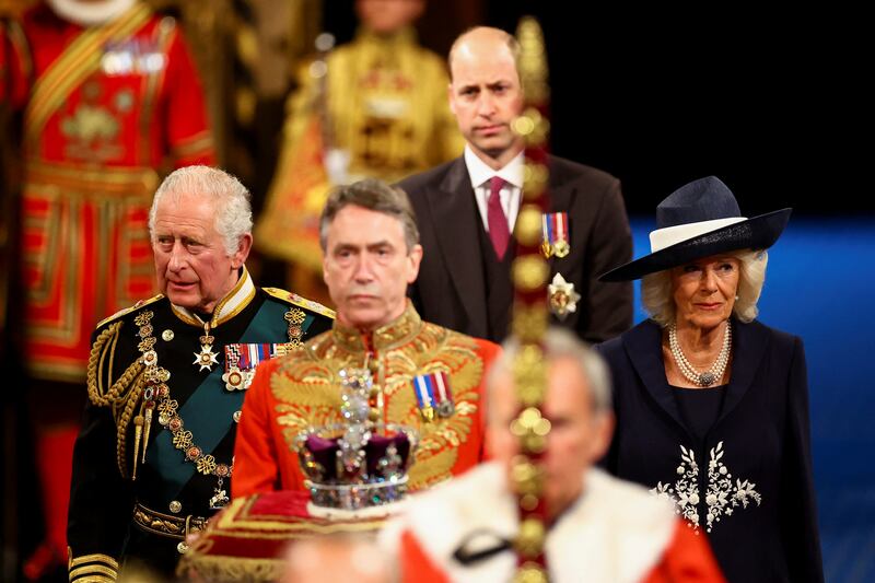 Prince Charles, Camilla, the Duchess of Cornwall, and Prince William follow the Imperial State Crown through the Royal Gallery for the State Opening of Parliament. Getty Images