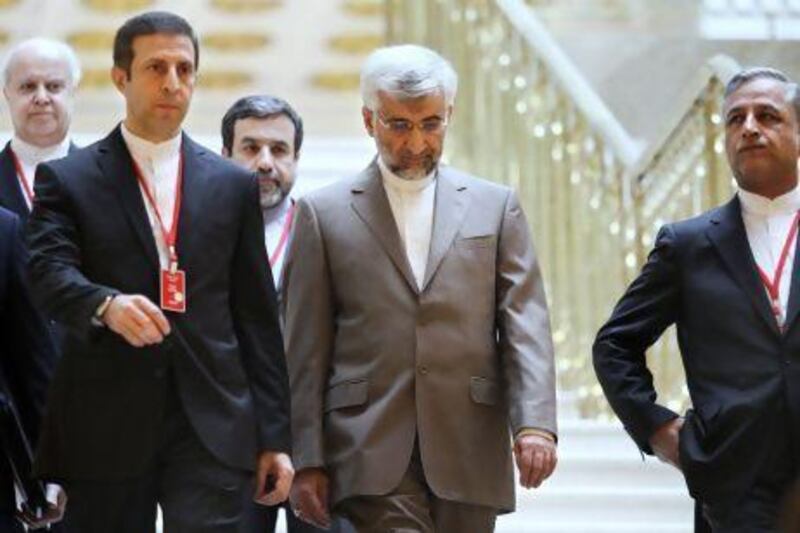 Saeed Jalili, Iran's chief nuclear negotiator, centre, heads an Iranian delegation into talks with world powers on Tuesday. Stanislav Filippov / AP Photo