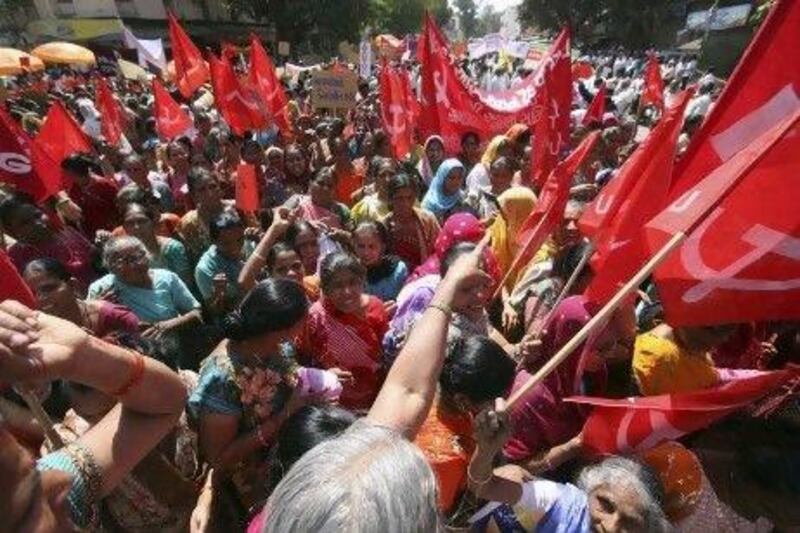 Workers march in the western Indian city of Ahmedabad yesterday during their one-day strike for better rights. Hundreds of thousands of them from several trade unions downed tools across India to express their anger at soaring prices and to back demands for a better deal.