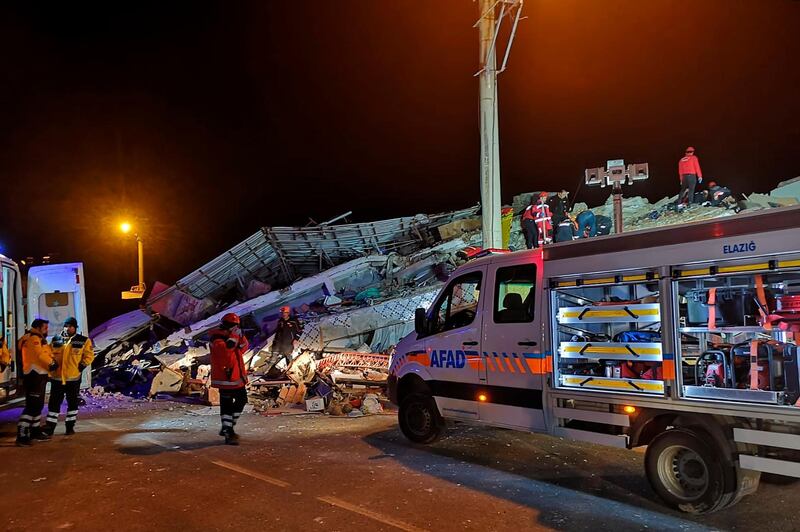 Rescue workers on a collapsed building after a strong earthquake struck Sivrice town in Elazig province, eastern Turkey. AP