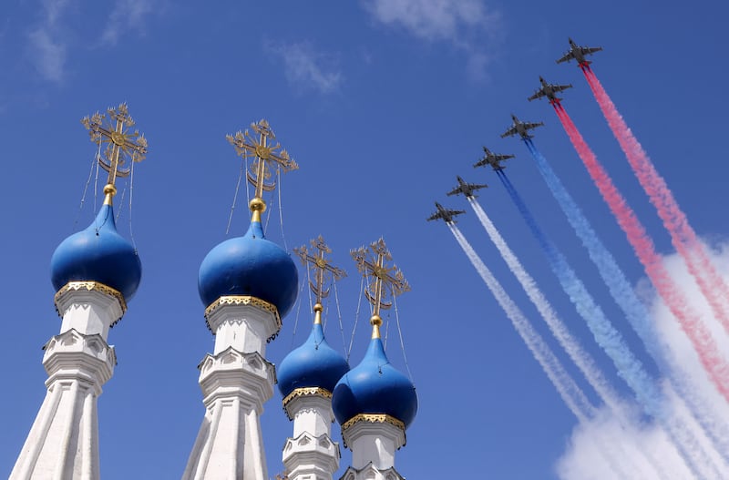 Russian Su-25 jet aircraft release smoke in the colours of the Russian state flag during the rehearsal for the flypast.  Reuters