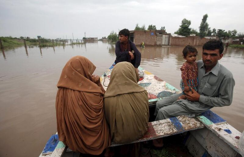 Rescue crews evacuate a family in the Pura. Fayaz Aziz / Reuters