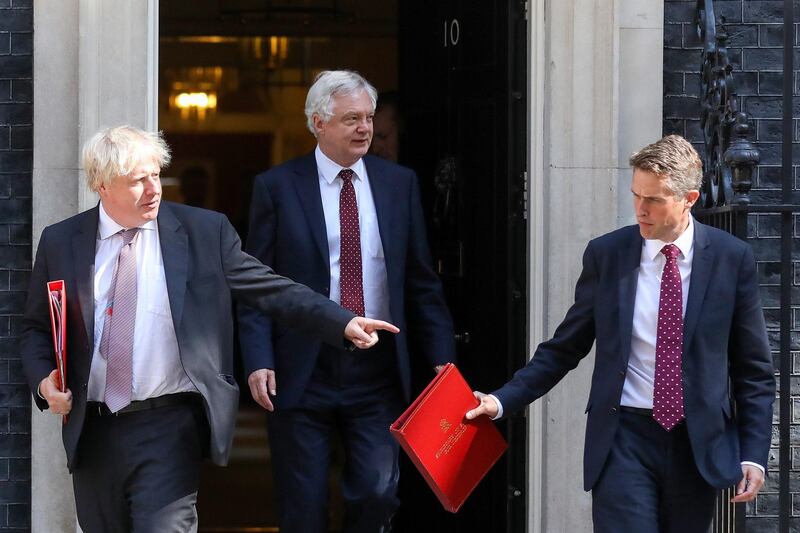 Boris Johnson, U.K. foreign secretary, left, David Davis, U.K. exiting the European Union (EU) secretary, centre, and Gavin Williamson, U.K. defence secretary, leave after attending a meeting of cabinet minsters at number 10 Downing Street in London, U.K., on Tuesday, July 3, 2018. U.K. Prime Minister Theresa May's efforts to unite her top team come ahead of a crucial meeting of her cabinet at her country estate Friday, when ministers are due to agree Britain's blueprint for its future relationship with the EU. Photographer: Chris Ratcliffe/Bloomberg