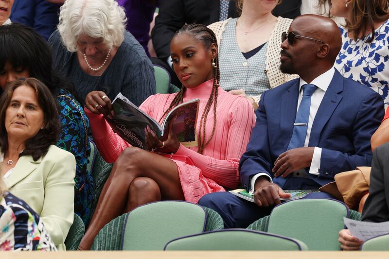 American actress Issa Rae, centre, with her husband Louis Diame at the All England Club. AFP