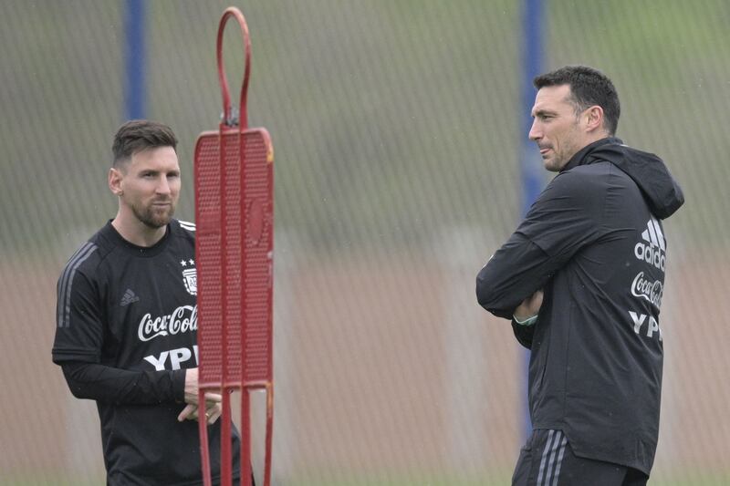 Argentina's coach Lionel Scaloni next to forward Lionel Messi. AFP