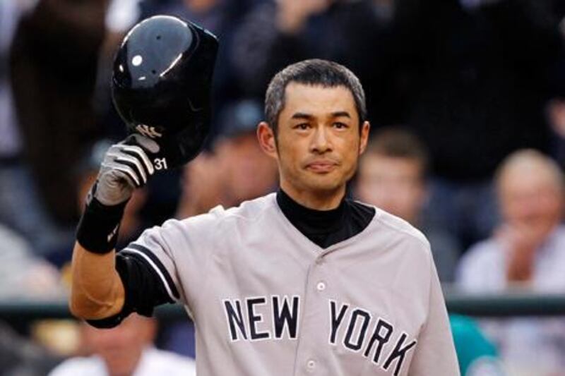 New York Yankees' Ichiro Suzuki doffs his helmet to the crowd.