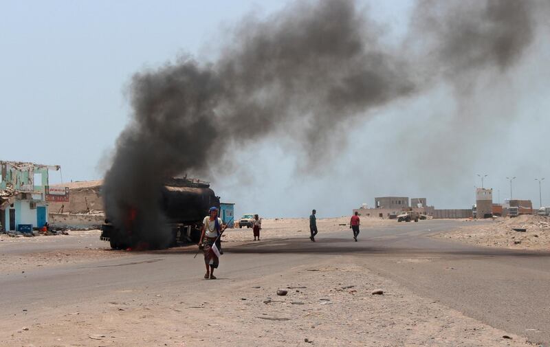 People inspect an oil tanker truck set ablaze during recent clashes between Yemeni southern separatists and government forces near Aden, Yemen, Friday, Aug. 30, 2019.Â Yemen's civil war started in 2014 when Shiite Houthi rebels overran the capital, Sanaa, and much of the country's north. A Saudi-led coalition of mostly Arab states intervened a year later to try and restore President Mansour Abed Rabbo Hadi to power. (AP Photo/Wail al-Qubaty)