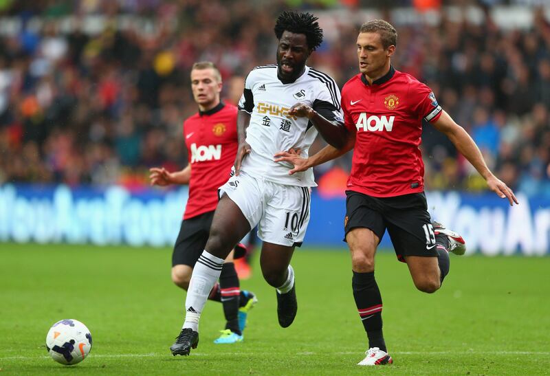 SWANSEA, WALES - AUGUST 17:  Wilfried Bony (L) of Swansea City is tracked by Nemanja Vidic (R) of Manchester United during the Barclays Premier League match between Swansea City and Manchester United at the Liberty Stadium on August 17, 2013 in Swansea, Wales.  (Photo by Michael Steele/Getty Images) *** Local Caption ***  176701606.jpg