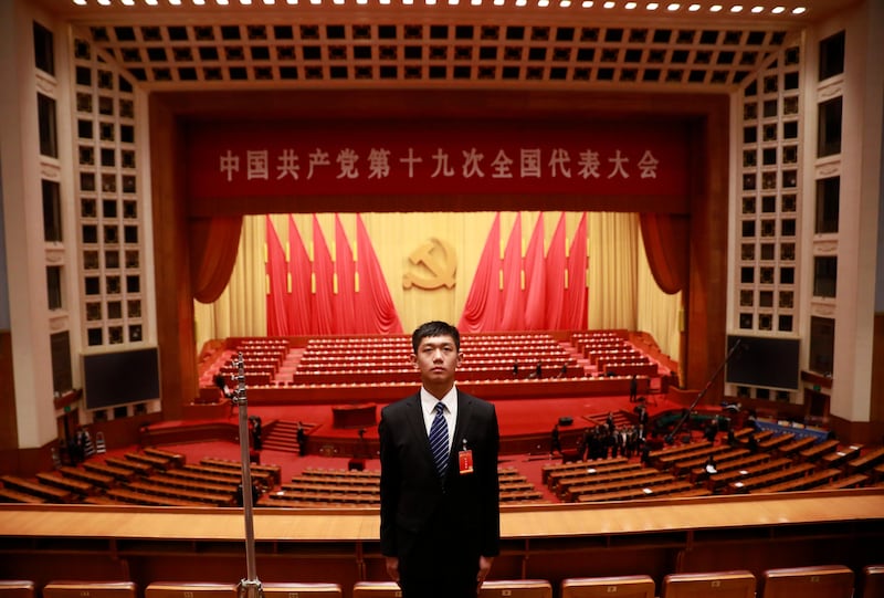 A Chinese security officer stand guard in the hall after the opening ceremony.  How Hwee Young / EPA