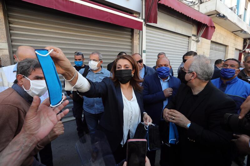 Mayor of the municipality of Tunis Souad Abderrahim distributes free masks in front of the central market in Tunis. EPA
