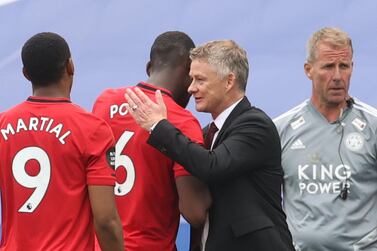 Manchester United's Norwegian manager Ole Gunnar Solskjaer (2R) congratulates Manchester United's French midfielder Paul Pogba (2L) at the end of the English Premier League football match between Leicester City and Manchester United at King Power Stadium in Leicester, central England on July 26, 2020. RESTRICTED TO EDITORIAL USE. No use with unauthorized audio, video, data, fixture lists, club/league logos or 'live' services. Online in-match use limited to 120 images. An additional 40 images may be used in extra time. No video emulation. Social media in-match use limited to 120 images. An additional 40 images may be used in extra time. No use in betting publications, games or single club/league/player publications. / AFP / POOL / CARL RECINE / RESTRICTED TO EDITORIAL USE. No use with unauthorized audio, video, data, fixture lists, club/league logos or 'live' services. Online in-match use limited to 120 images. An additional 40 images may be used in extra time. No video emulation. Social media in-match use limited to 120 images. An additional 40 images may be used in extra time. No use in betting publications, games or single club/league/player publications.