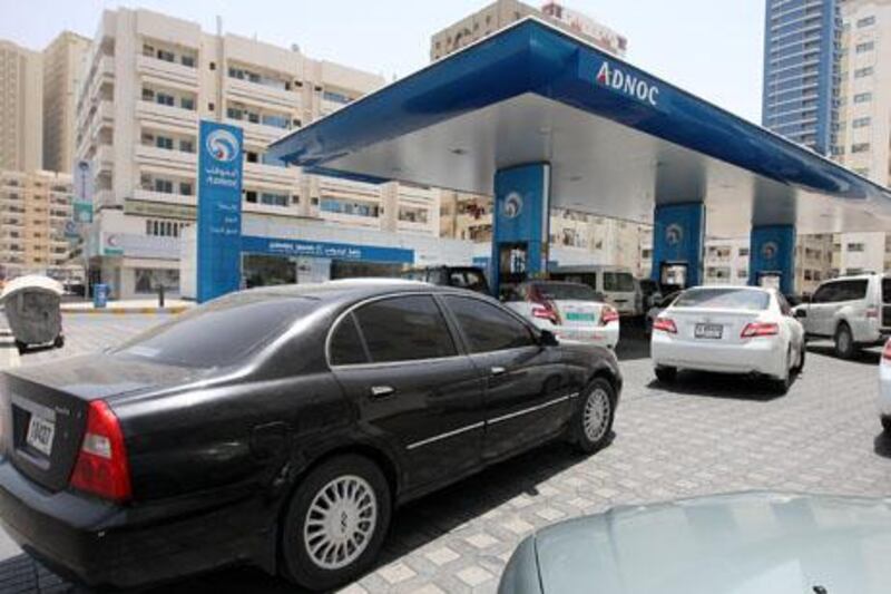 
SHARJAH , UNITED ARAB EMIRATES Ð May 13 , 2013 : Motorist refueling their cars at the ADNOC gas station near King Faisal road in Sharjah. ( Pawan Singh / The National ) For News. Story by Yasin Kakande
