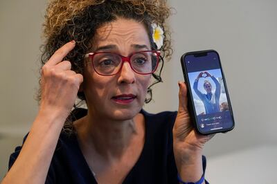 Masih Alinejad holds up a photo of an Iranian woman who was killed during protests in Iran. AP